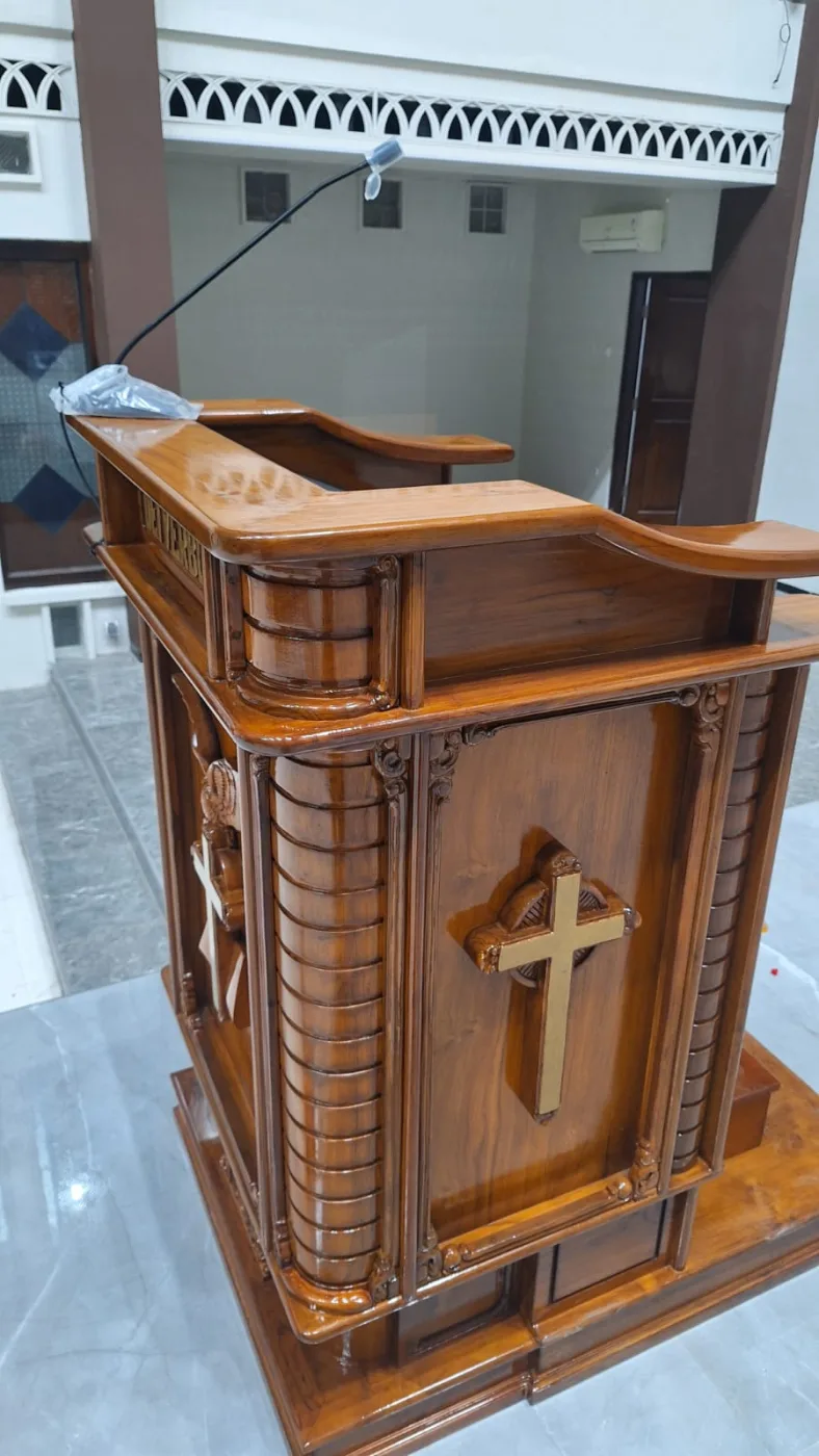 A microphone at the ambo, integrated into the wooden lectern.